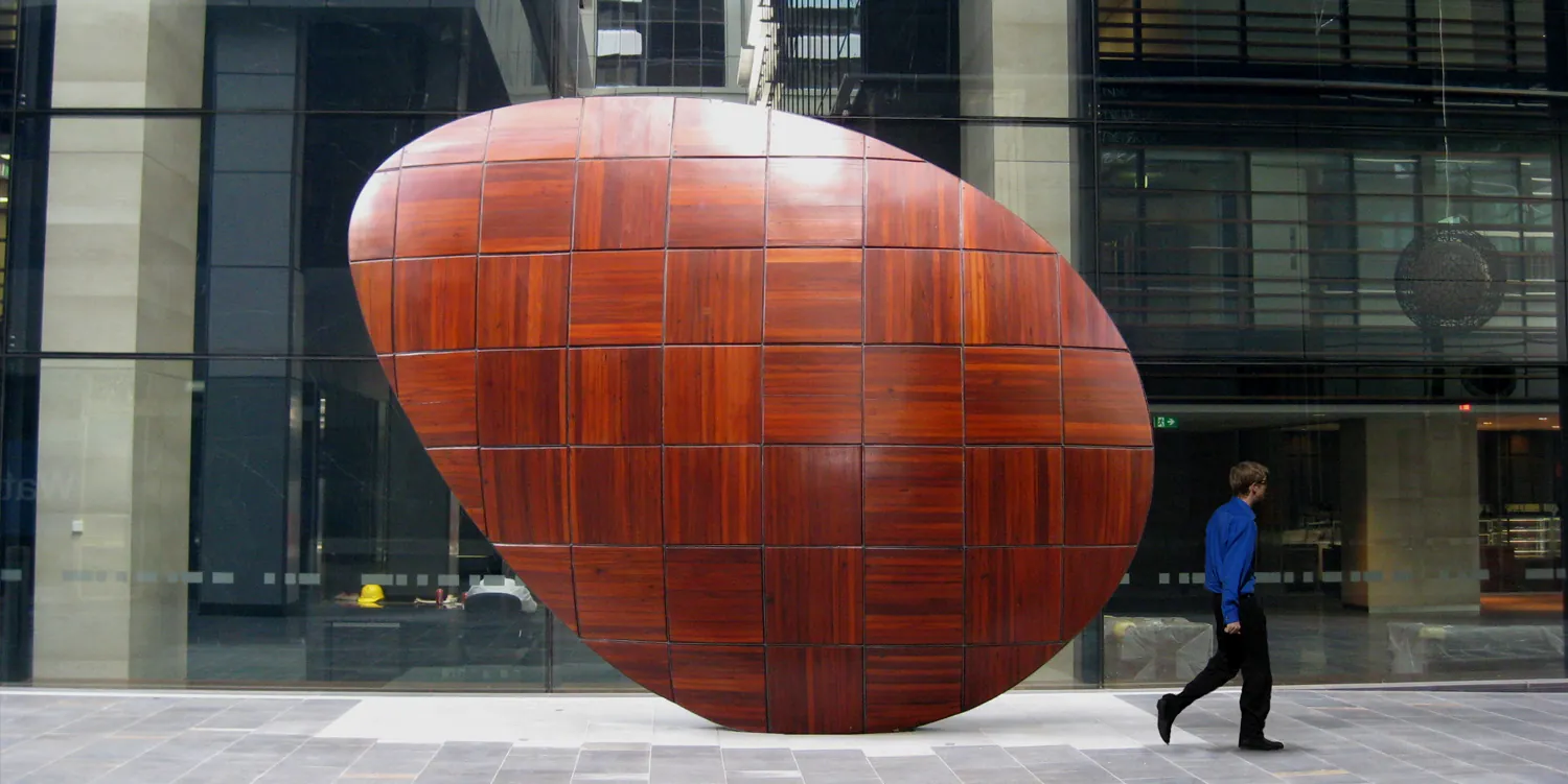A picture of a big
red rock with engraved squares, and a glass building in the background. The
photograph is called 'Kernel', by Stuart Green.